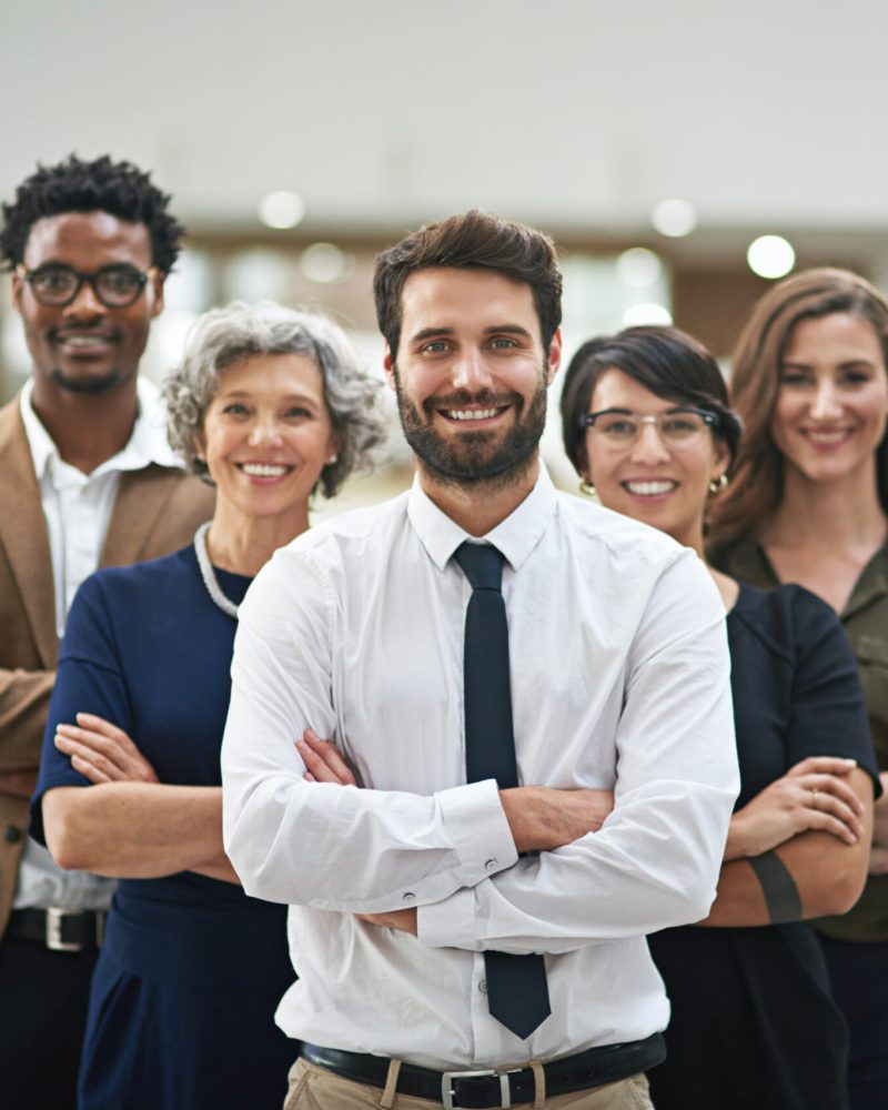 Team, arms crossed and smile for mentor, group and company in office for colleagues in business. Businesspeople, happy and confident with coworkers in corporate, startup or organization for work.
