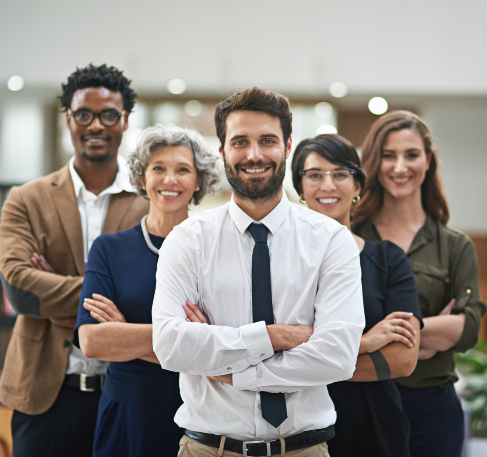 Team, arms crossed and smile for mentor, group and company in office for colleagues in business. Businesspeople, happy and confident with coworkers in corporate, startup or organization for work.